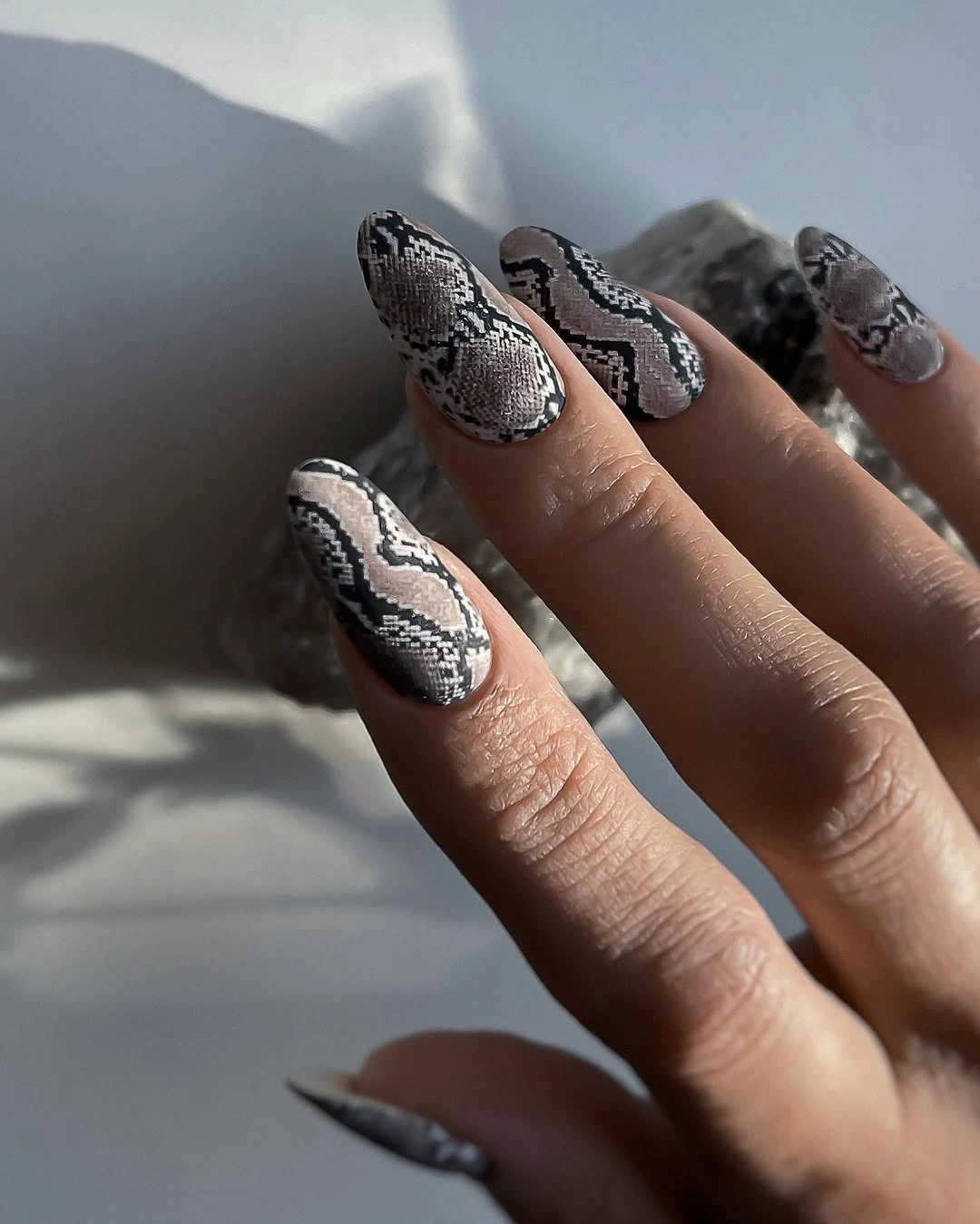 Gray snakeskin style nails on almond tips