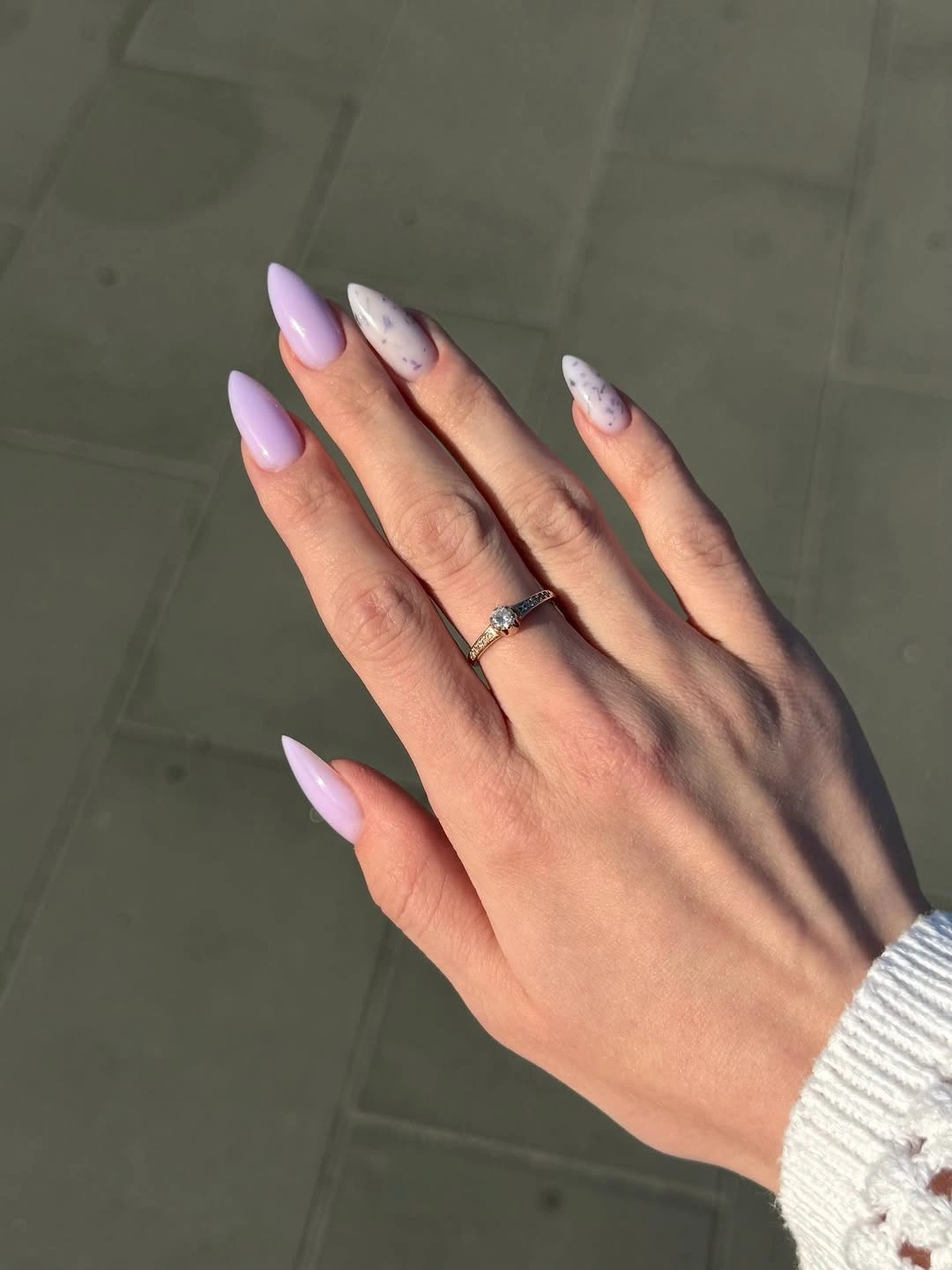 Lavender almond nails with white speckled accents