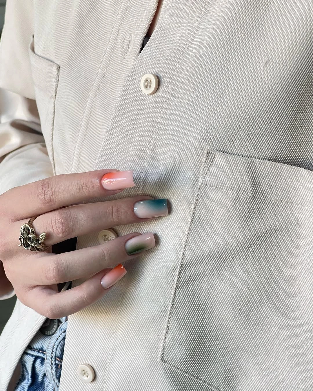 Sheer square nails with soft teal green and orange accents