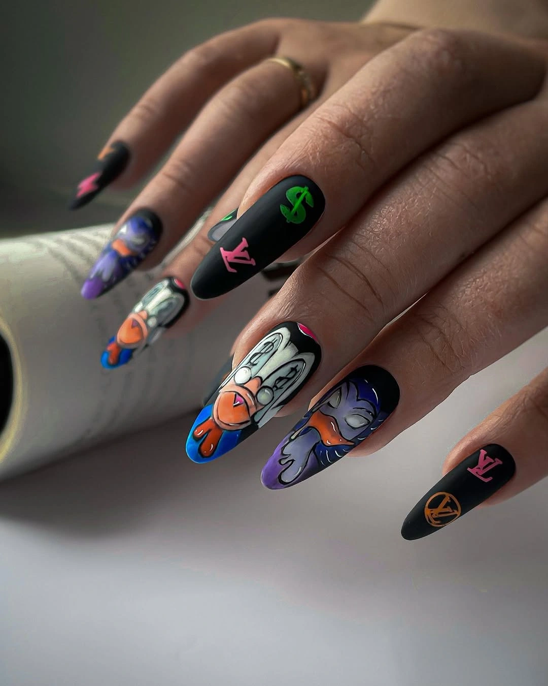 Black almond nails with colorful graphic accent art