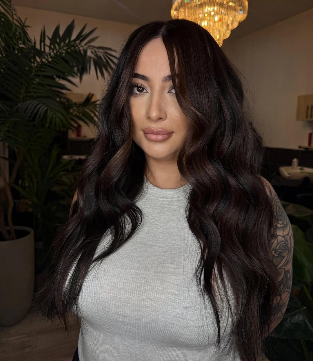 Very long brown hair in broad center parted waves