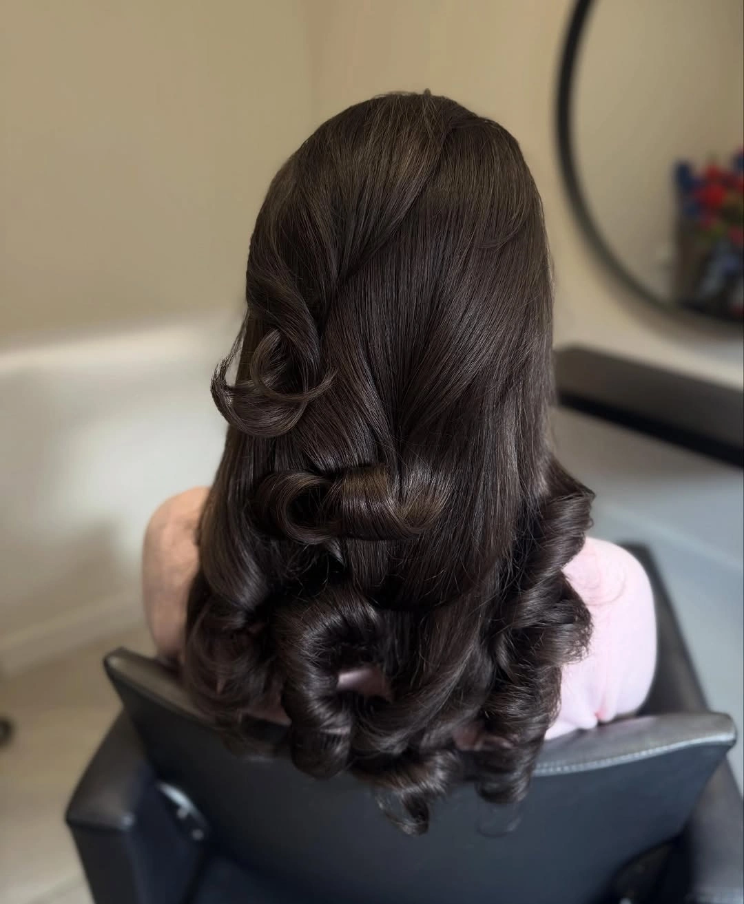 Long deep brown hair with sculpted waves through the ends