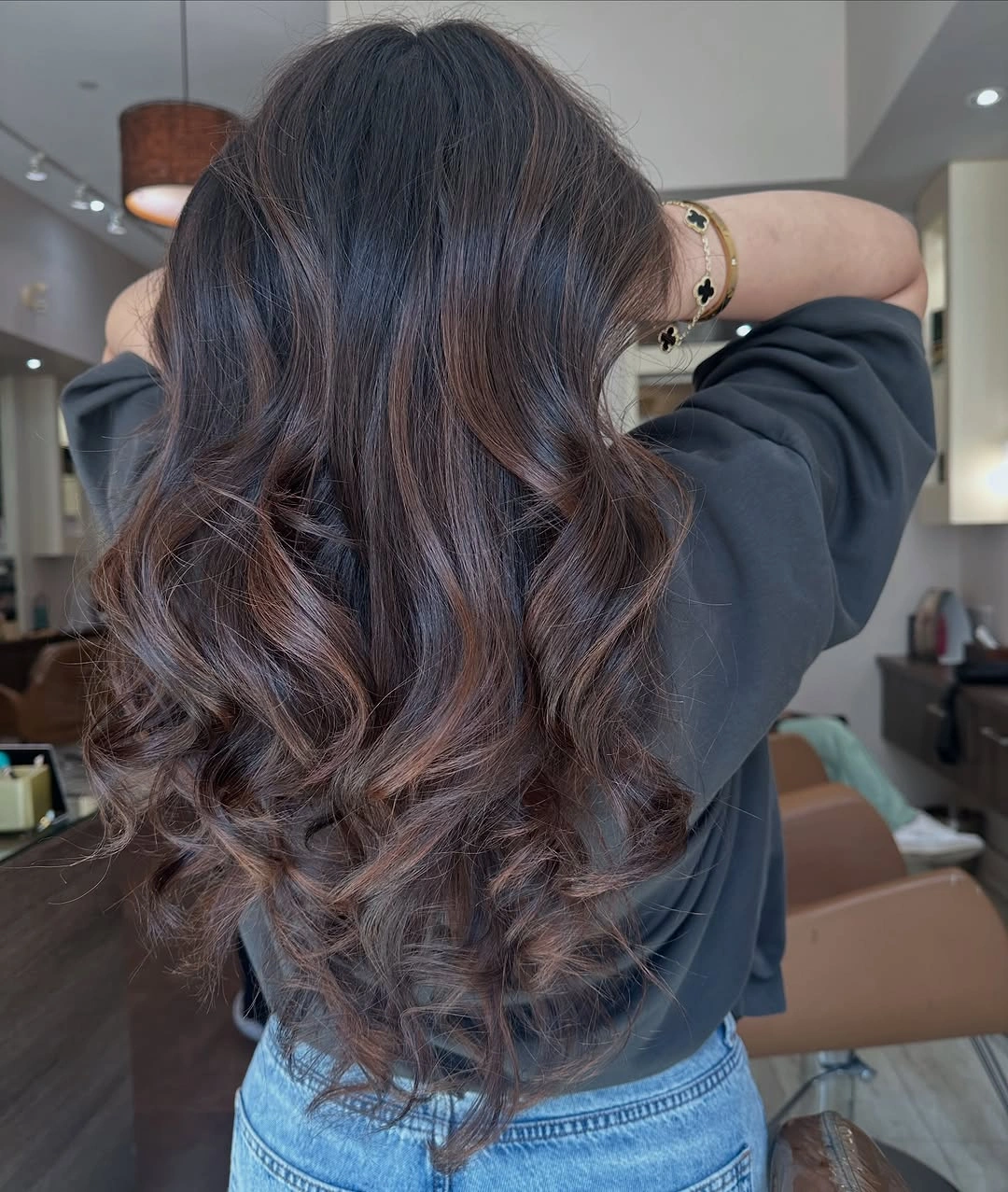 Long brown hair with cool taupe ribbons in airy curls