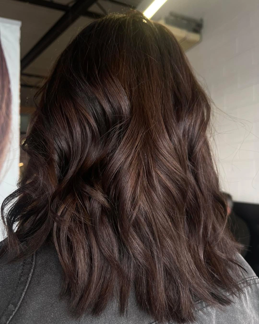 Long dark chocolate brown hair with full rounded waves