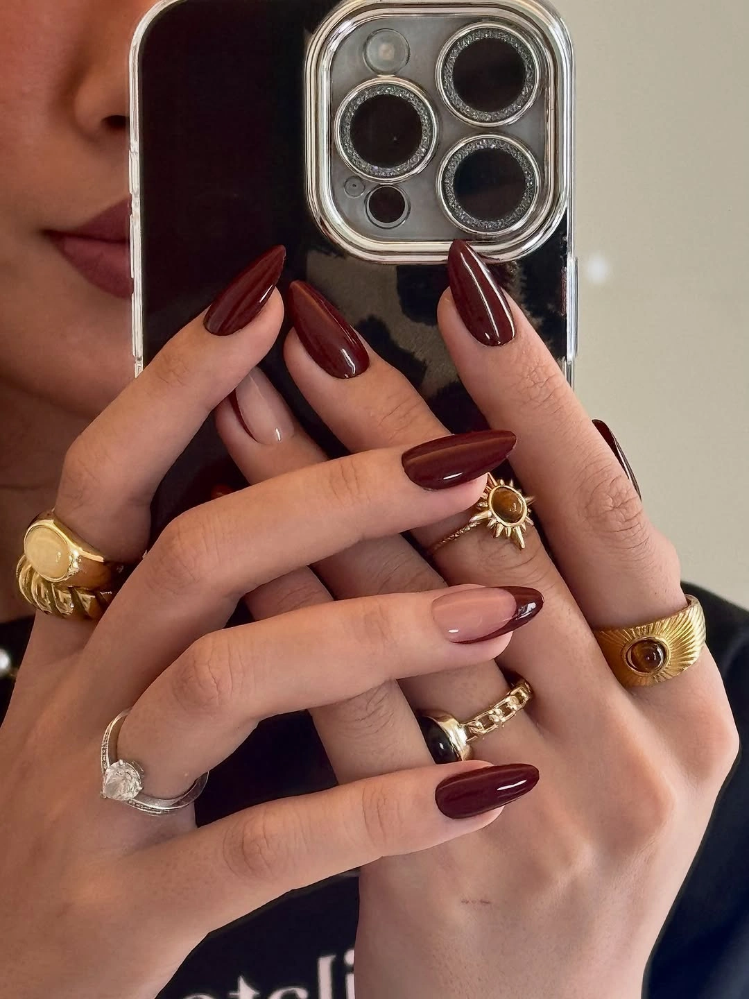 Medium almond dark burgundy nails with one nude pink accent