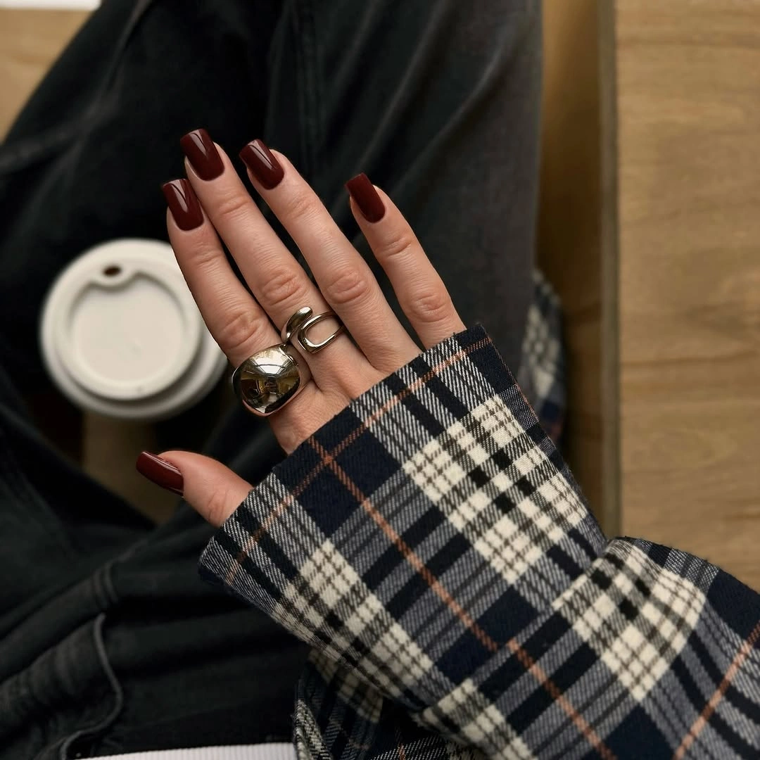 Long almond nails in solid burgundy with slim glossy highlights