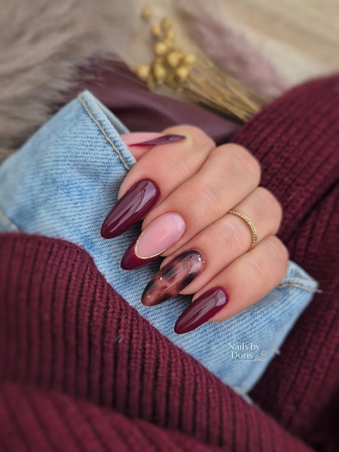 Long almond nails with burgundy side tips over a blush base