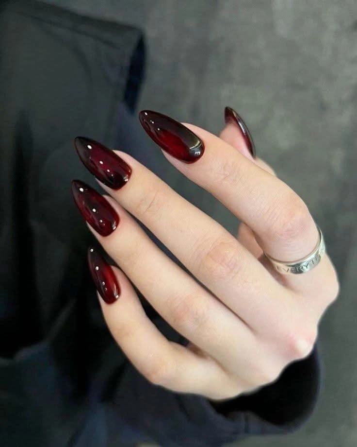 Long stiletto nails in a smooth deep burgundy finish