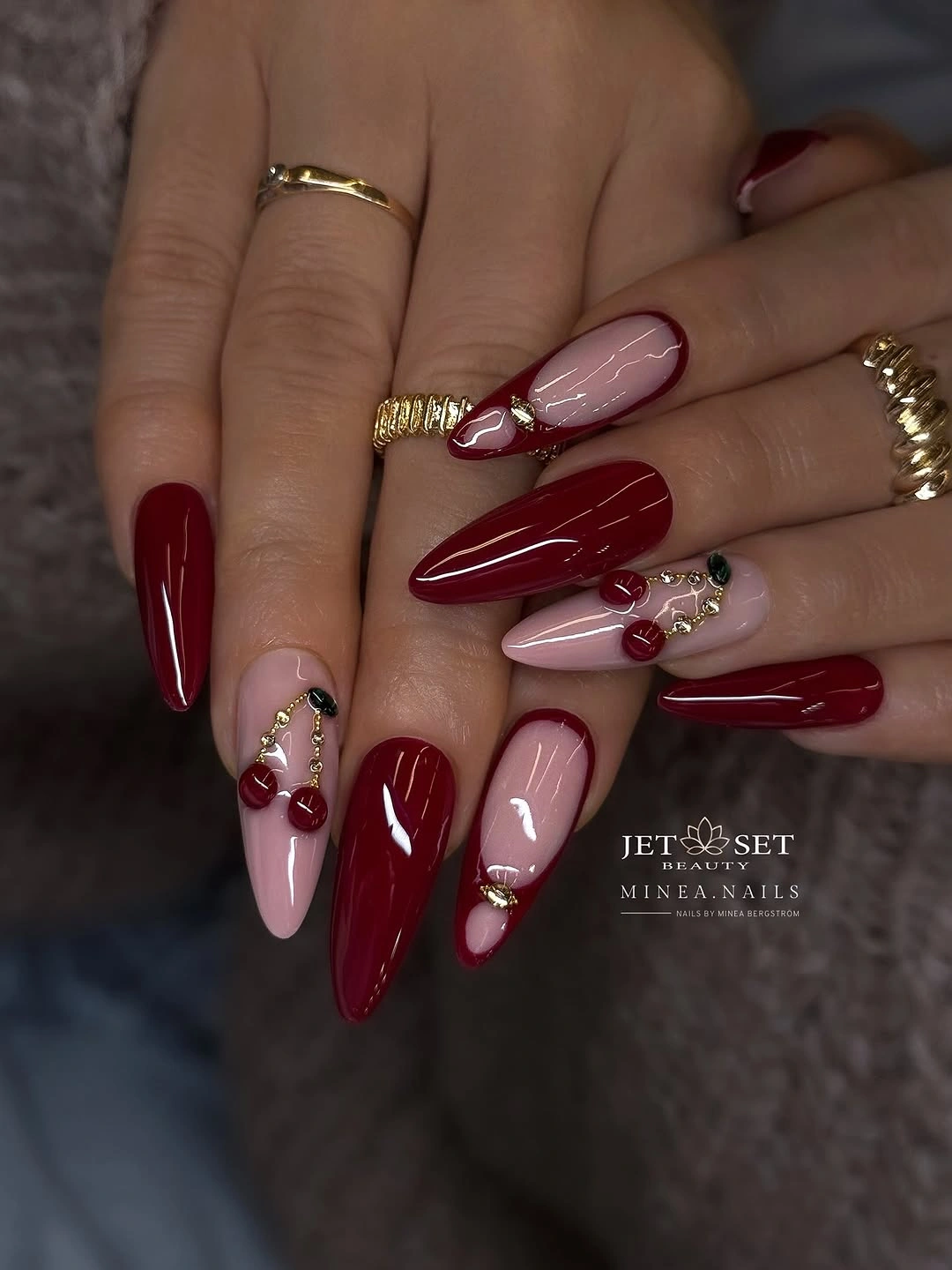 Long almond burgundy nails with blush sections and warm accents