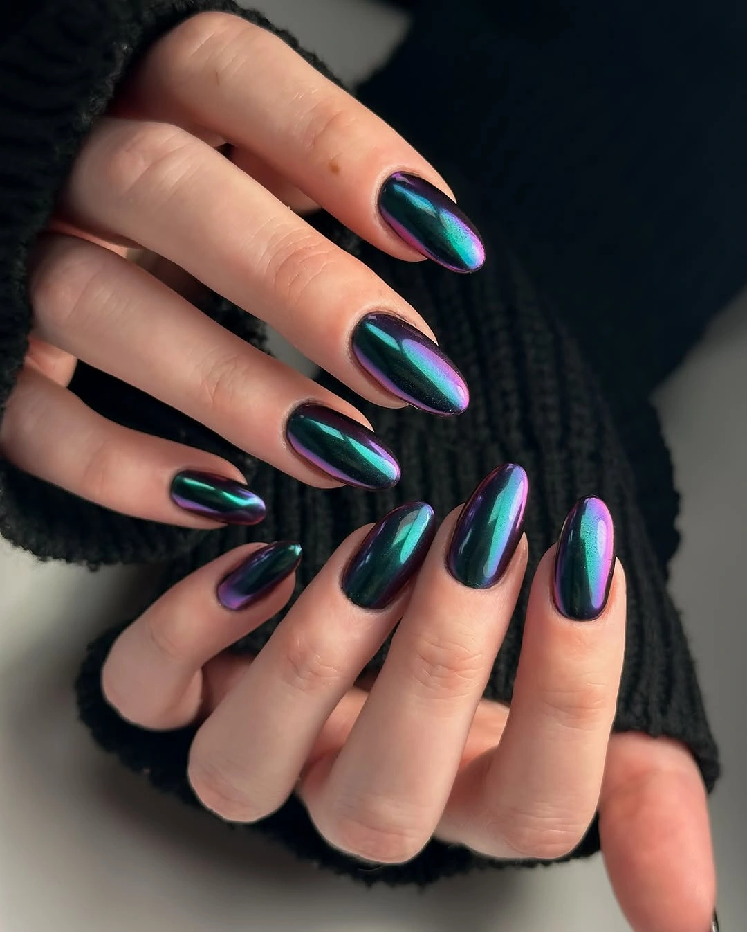 Long almond nails with smooth teal violet and green reflective shine