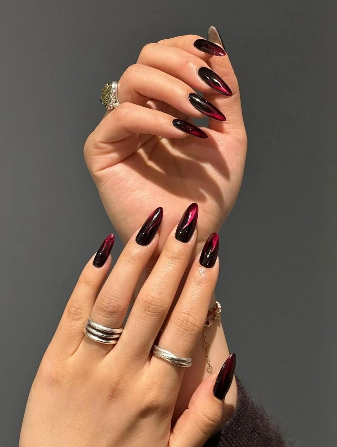Long almond nails in glossy blackened cherry wine color