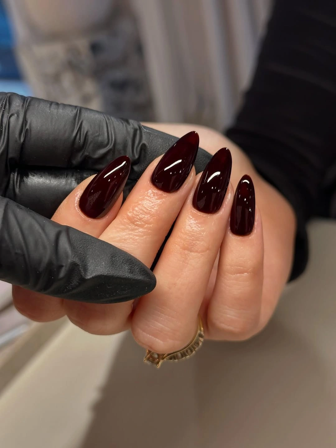 Glossy deep burgundy almond nails with rounded tips