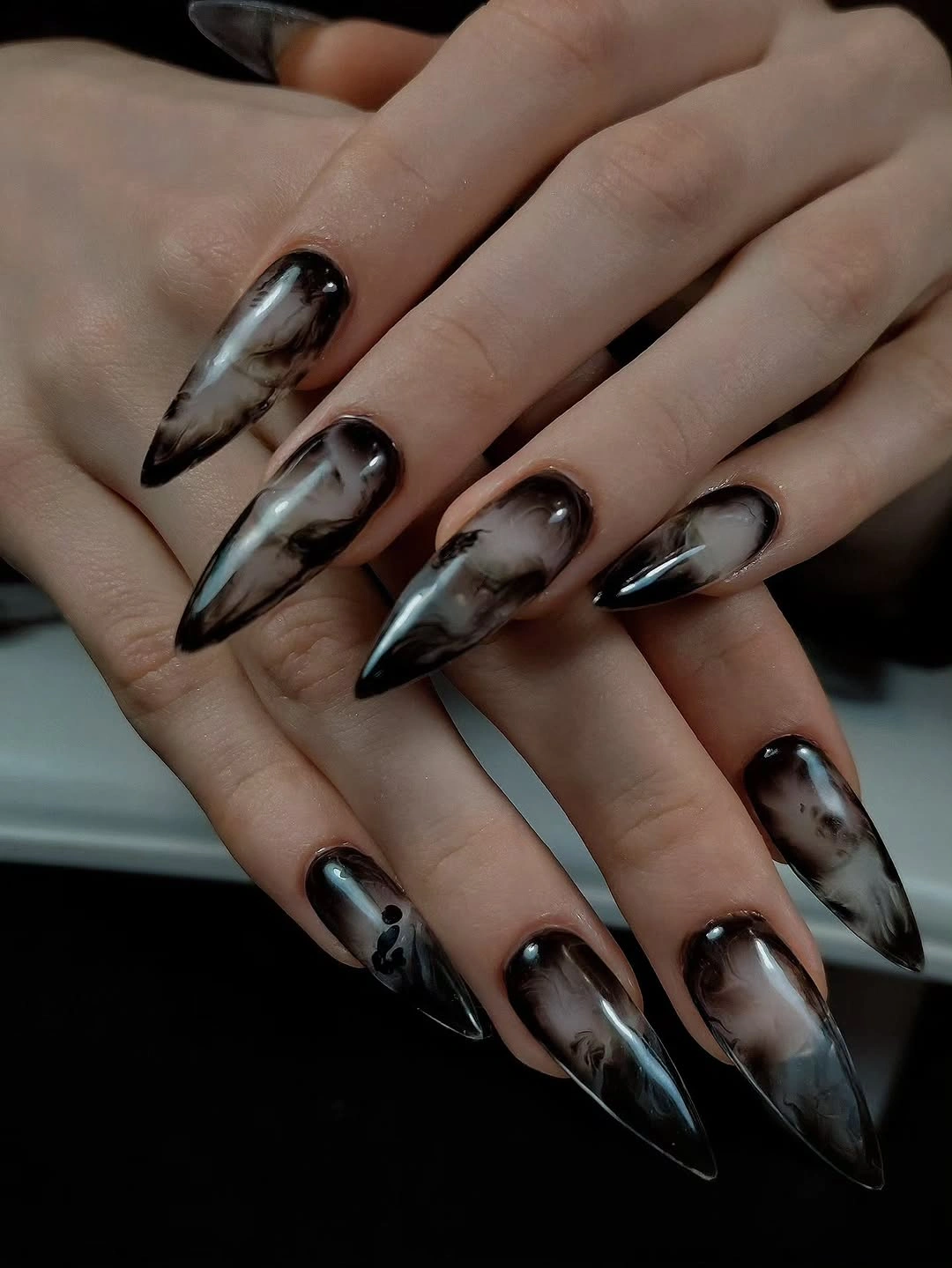 Long smoky stiletto nails with translucent gray black marble wisps