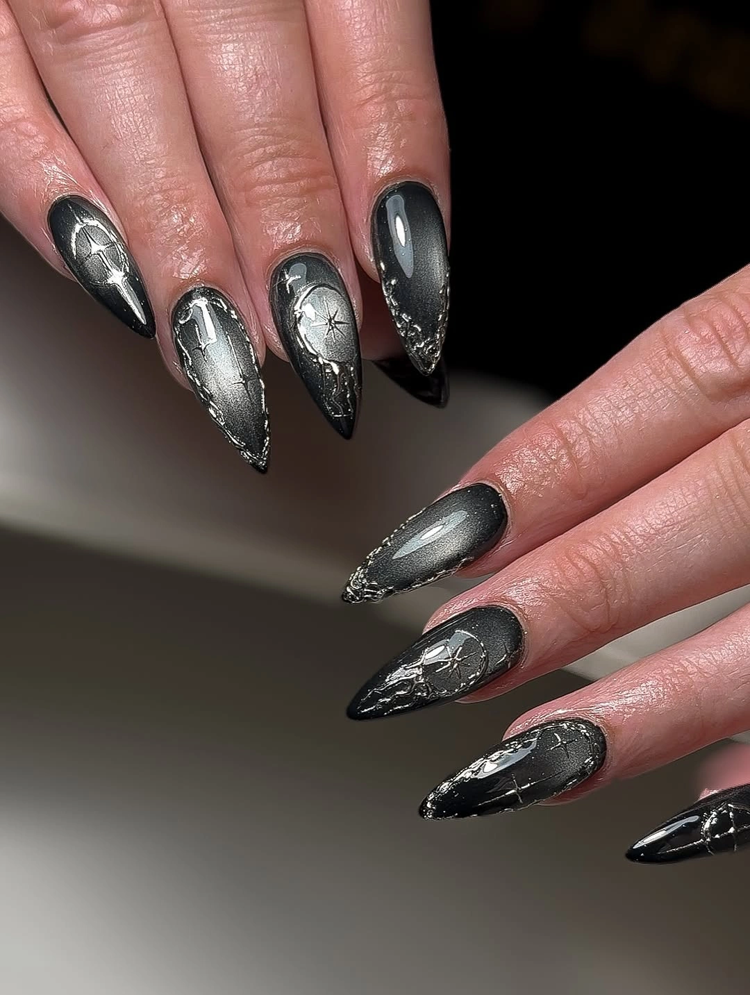 Charcoal and silver stiletto nails with fractured reflective accents