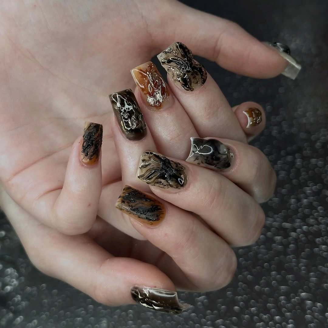 Short mixed nails with brown black amber and metallic texture