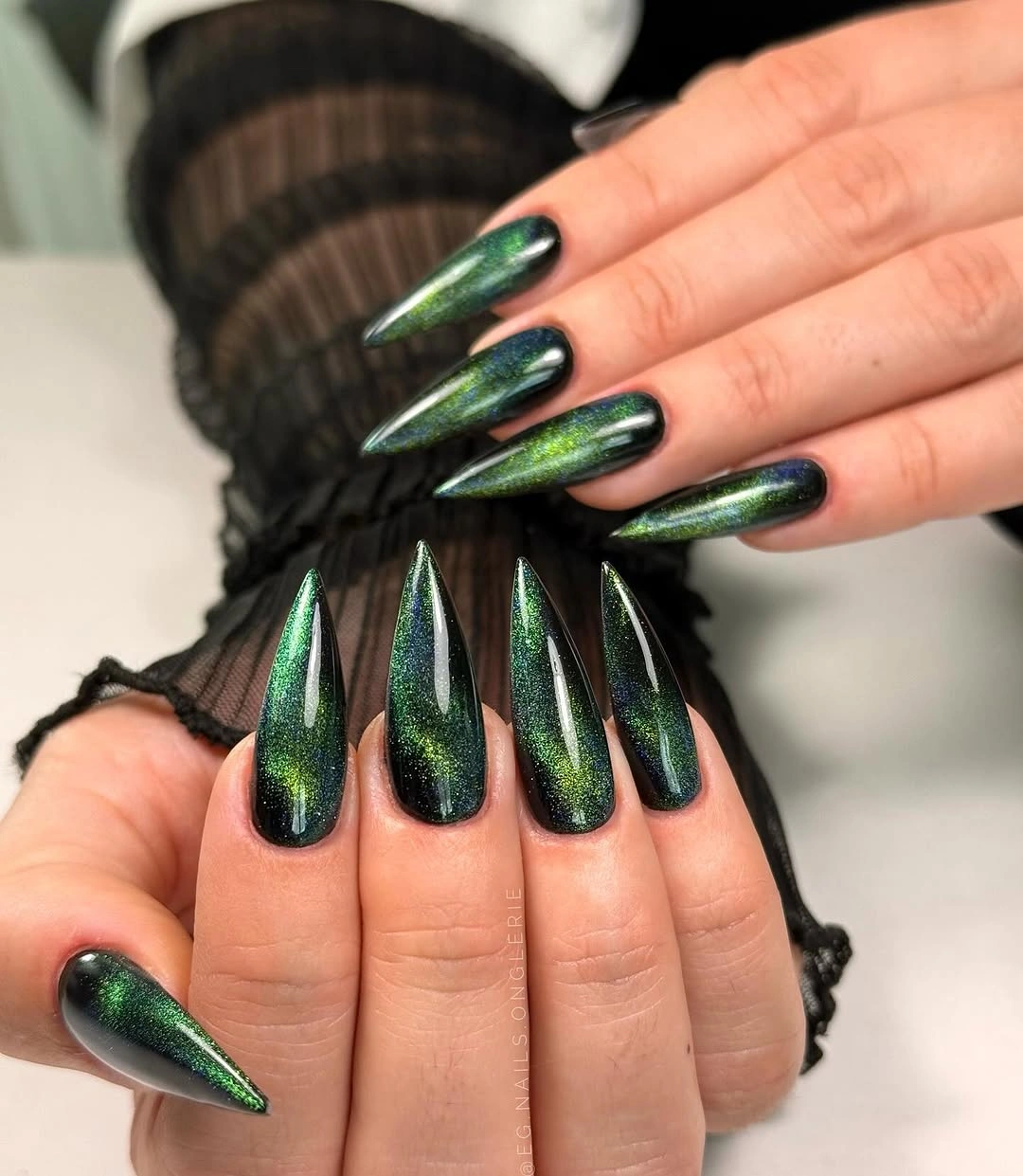 Long emerald stiletto nails with shifting blue green reflective color
