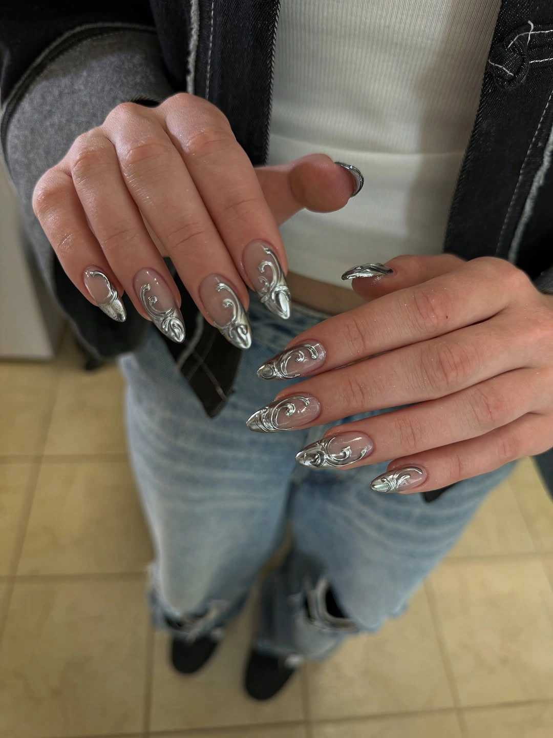 Long pointed nails with reflective silver swirl details