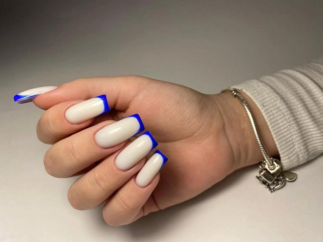 Short square milky nails with electric blue tips