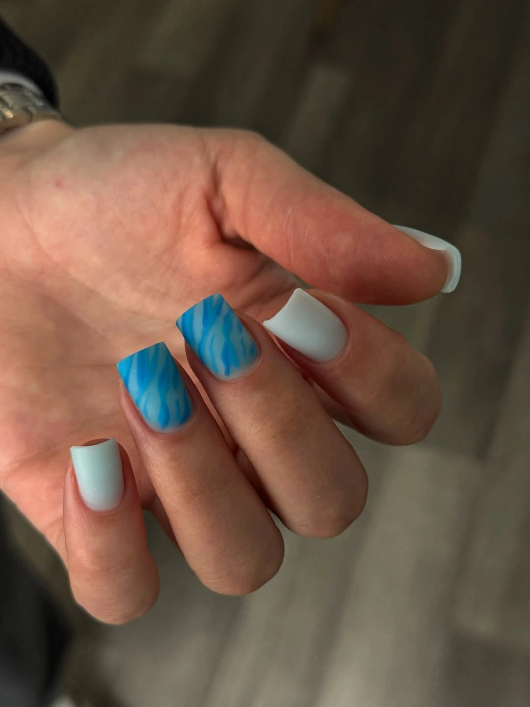 Short square white nails with vivid blue French tips