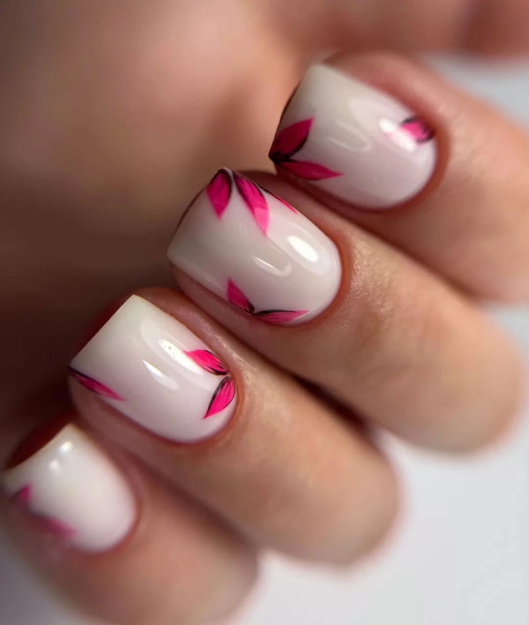 Short milky nails with abstract hot pink curved accents
