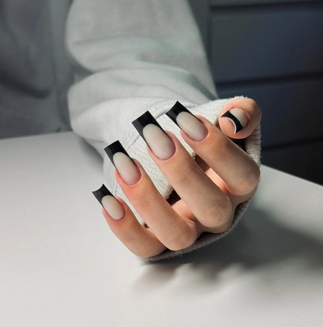 Long nude coffin nails with deep black French tips
