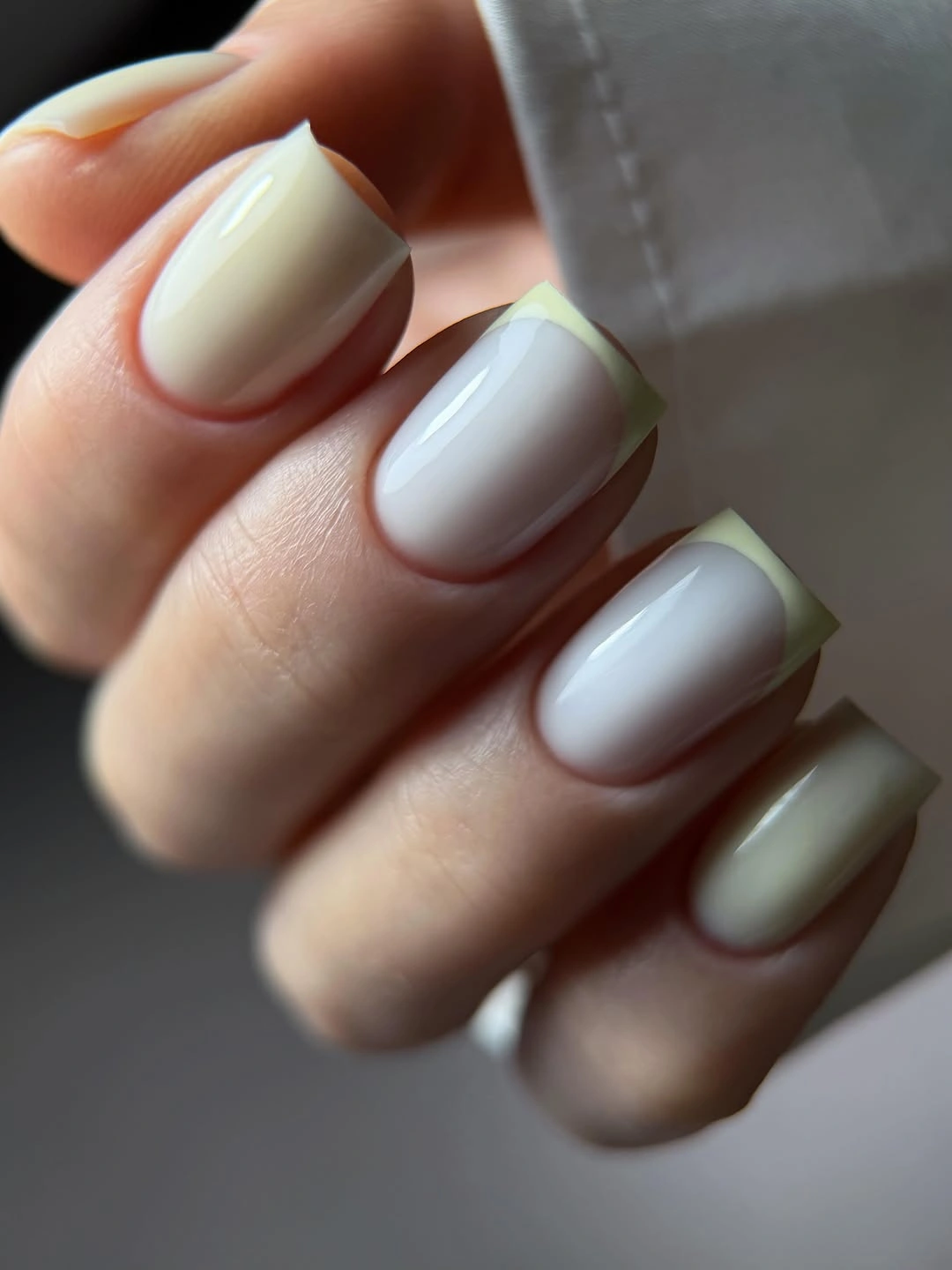 Short milky square nails with pale yellow green French edges