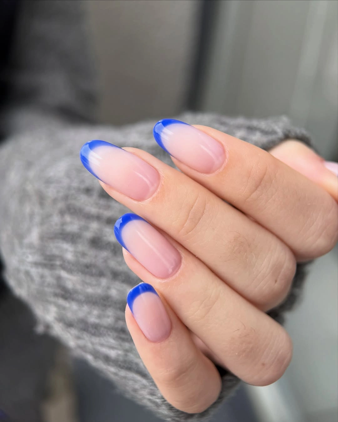 Long translucent pink almond nails with cobalt blue tips