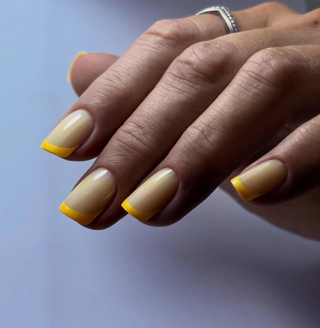 Warm beige square nails with sunny yellow French tips
