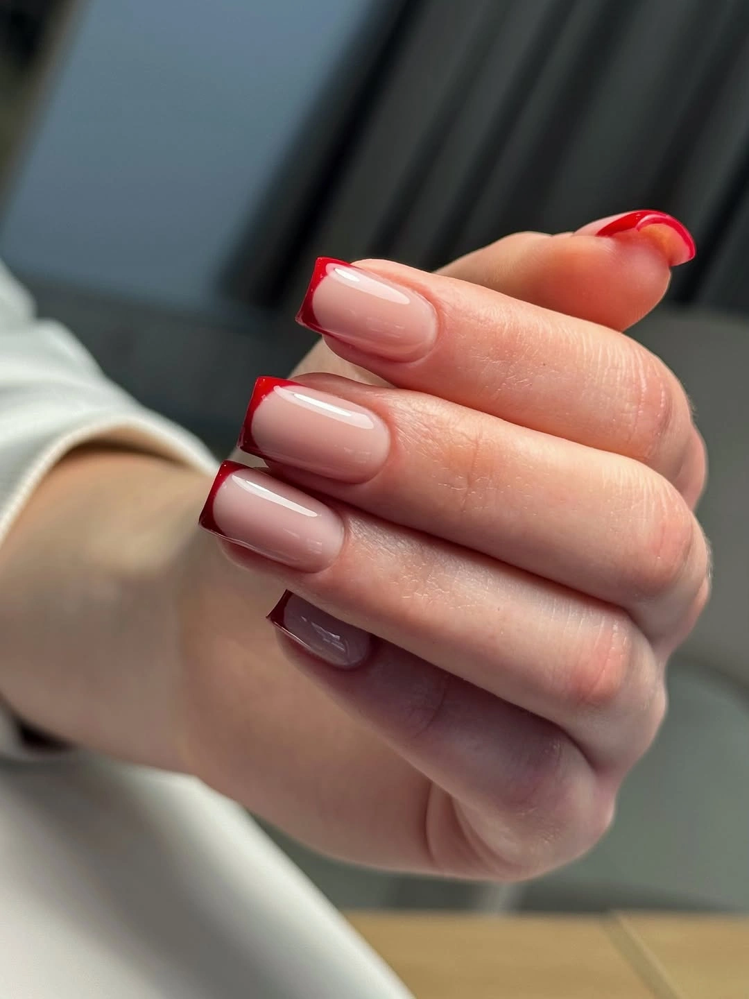 Nude square nails with vivid red French tips