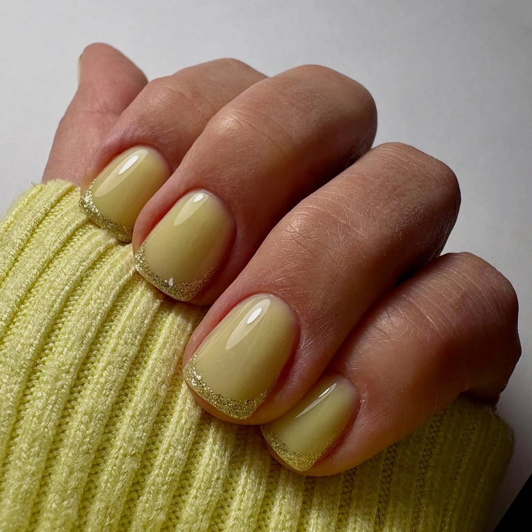 Short olive square nails with a fine glitter French border