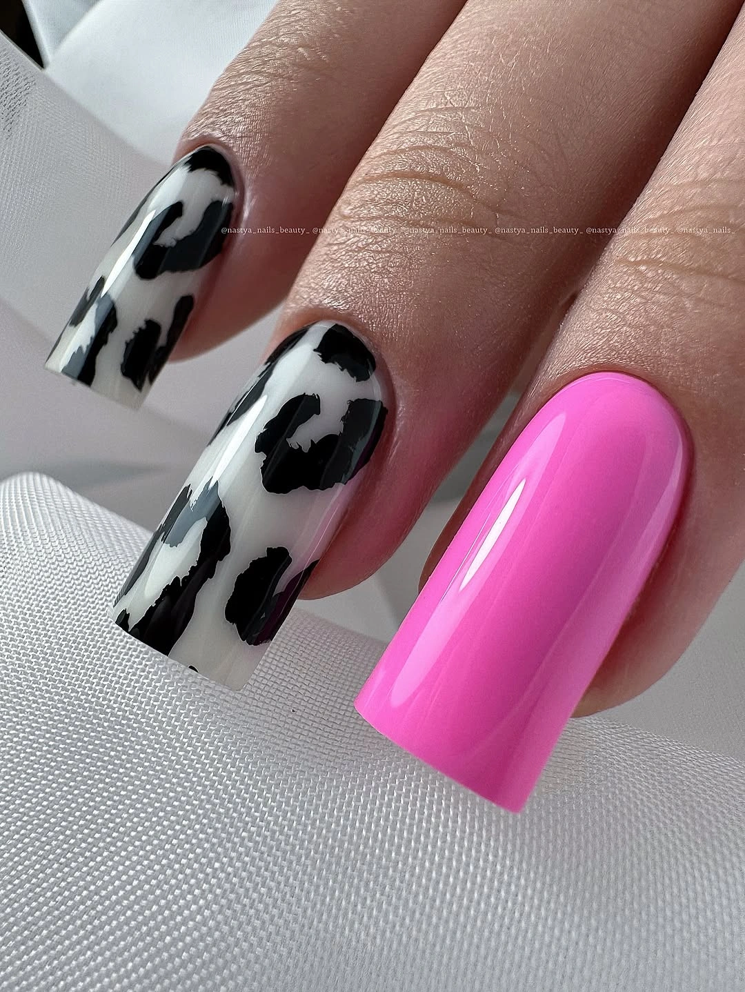 Long square black-white patch nails with a hot pink accent