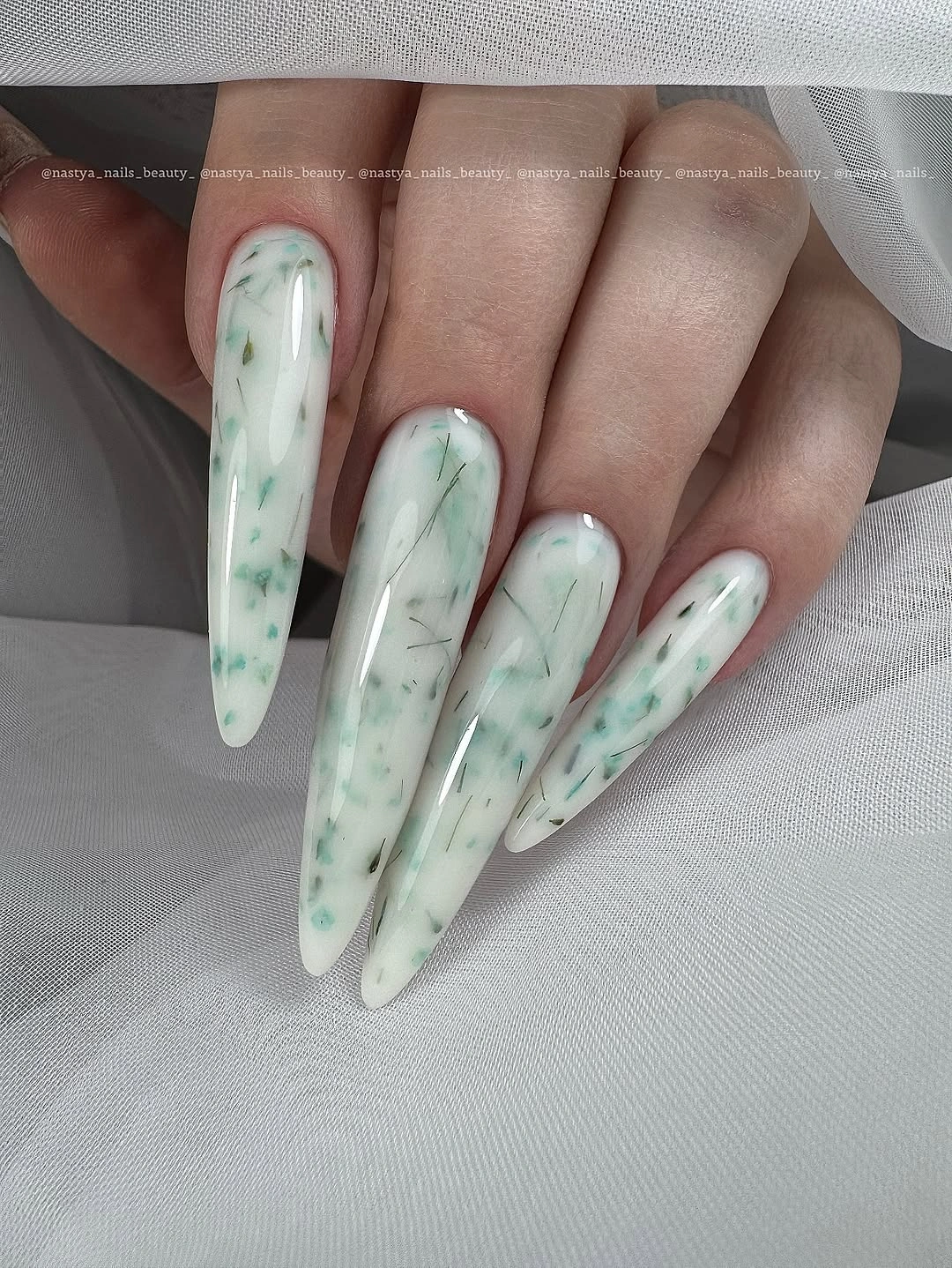 Long milky nails with pale mint swirls and green marks