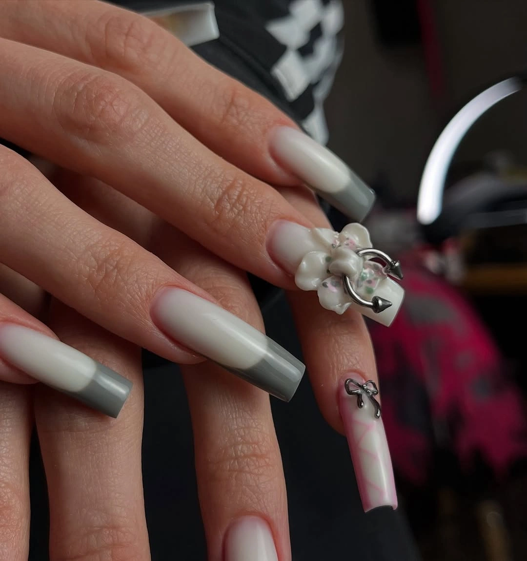 Long milky white tapered square nails with gray tips and floral accent