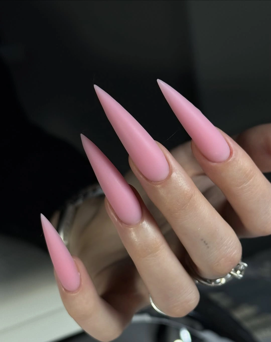 Long pointed nails in a soft glossy medium pink shade