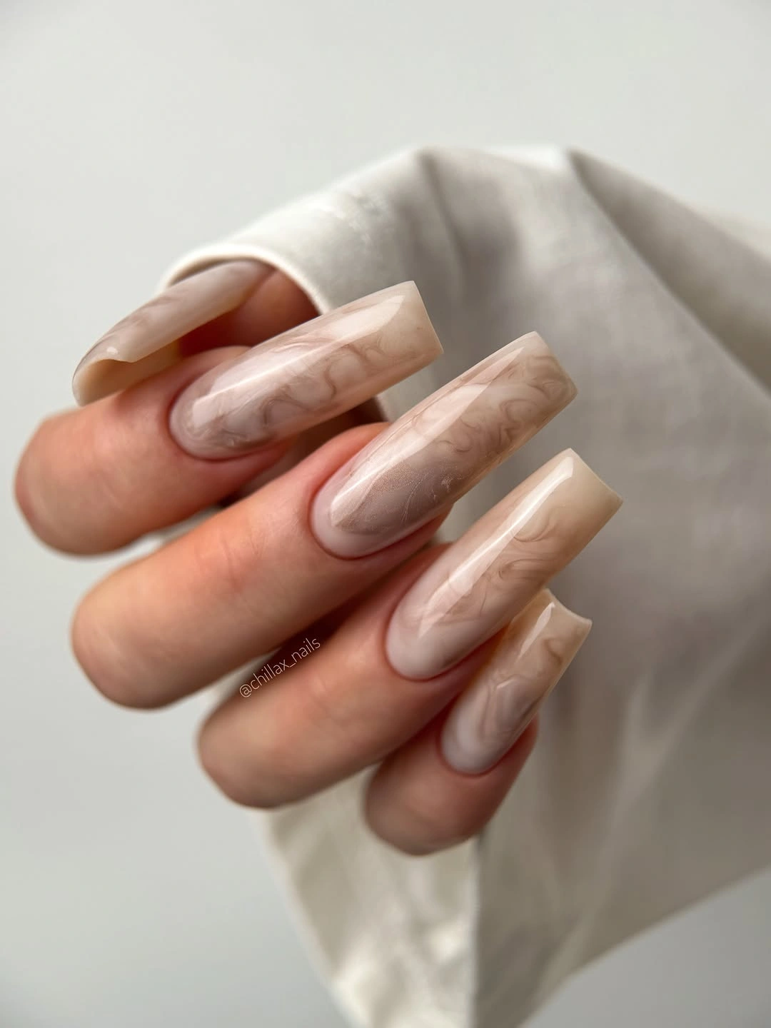 Long pale nude coffin nails with soft beige marble detail