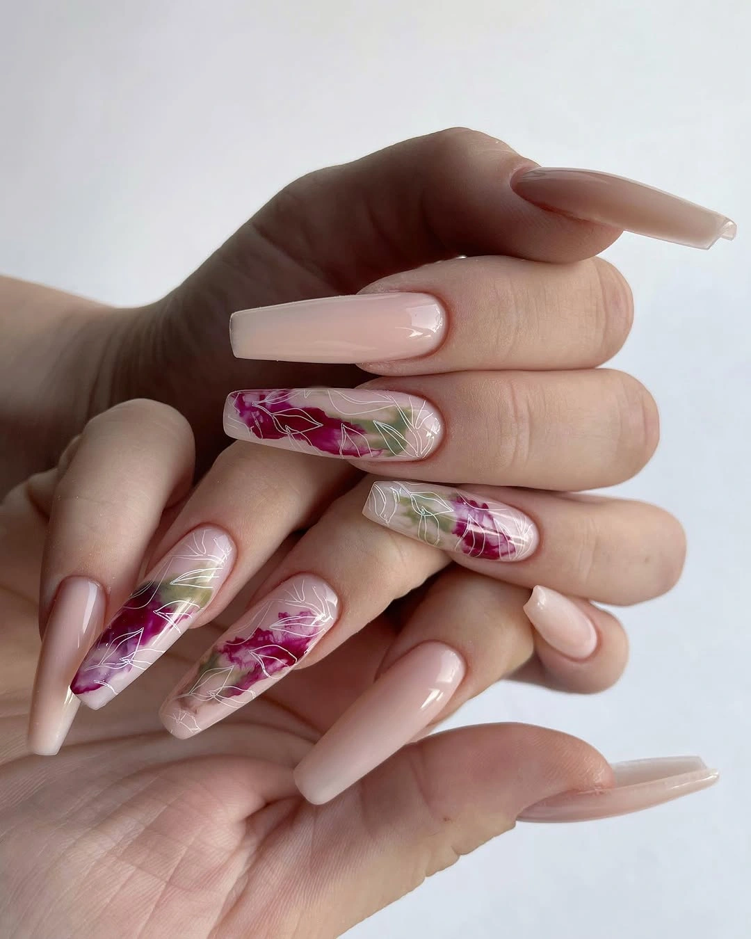 Long nude square nails with pink green and white abstract accents