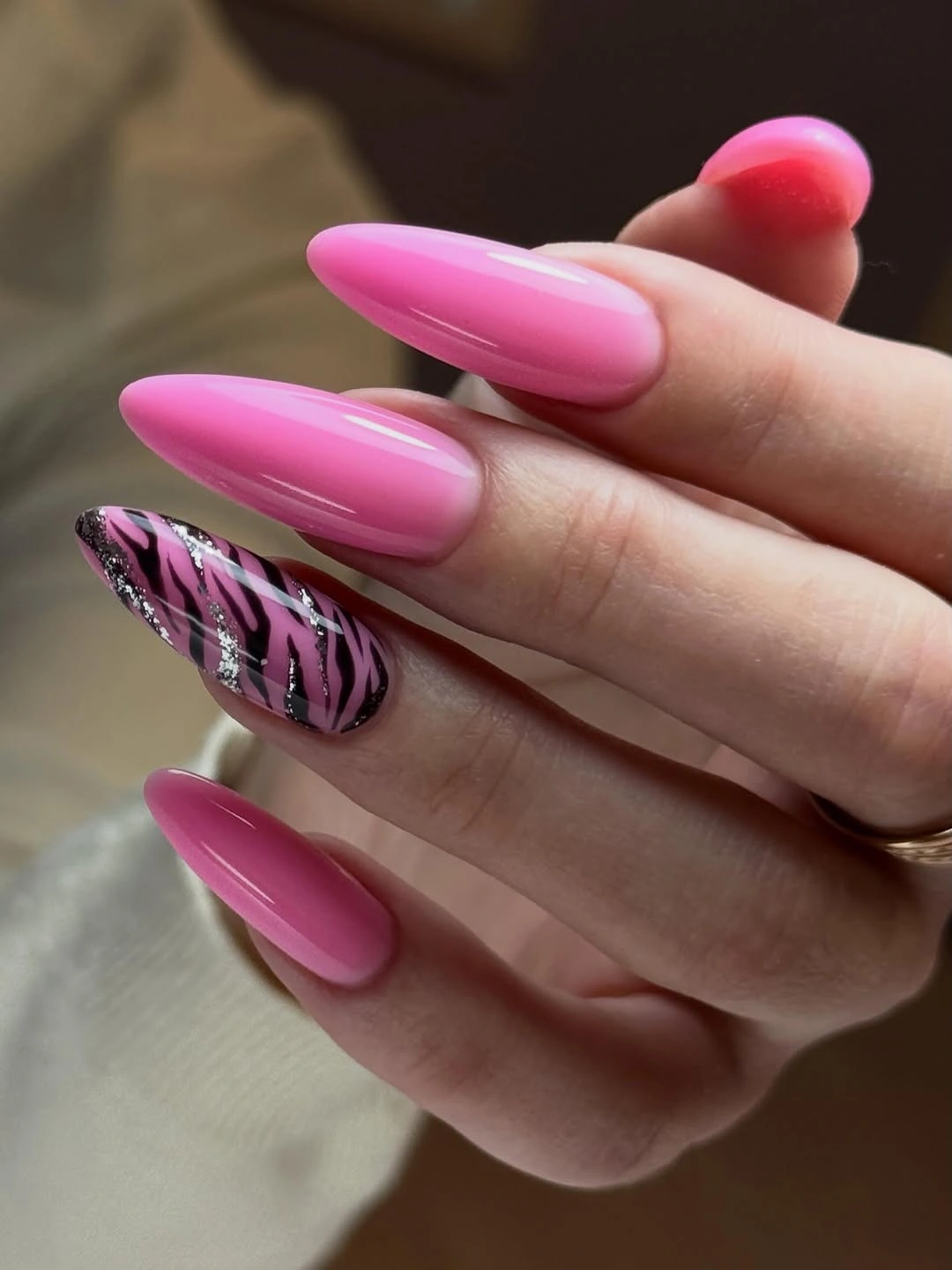 Long glossy hot pink almond nails with dark marbled accent