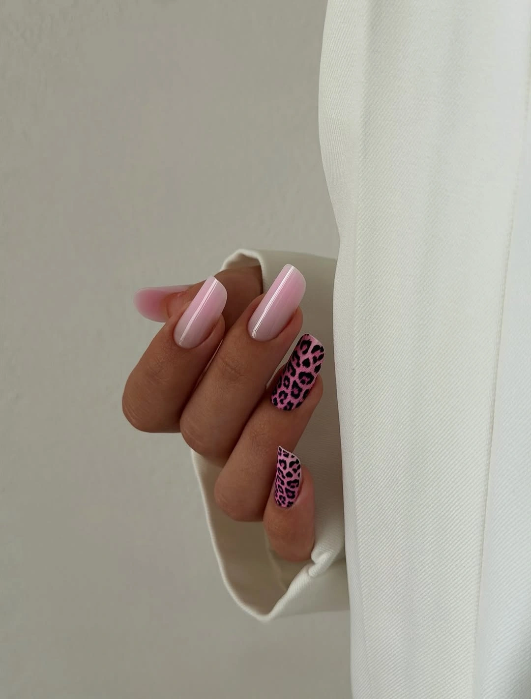 Long almond pale pink nails with darker spotted accents