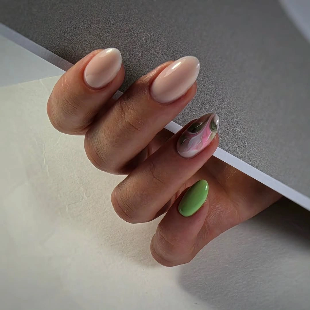 Short almond nails mixing soft pink with muted green