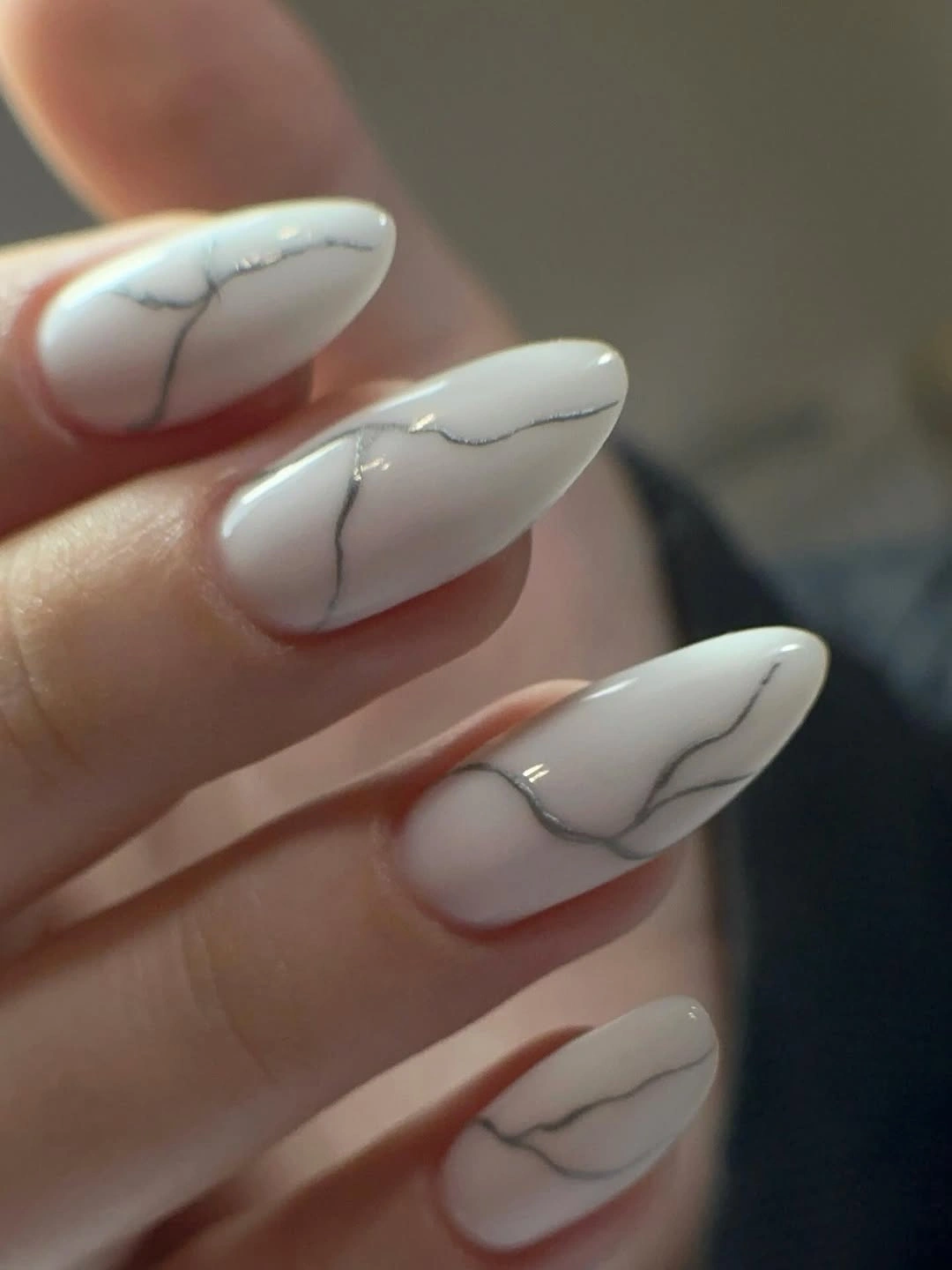 Long white almond nails with thin gray marble lines