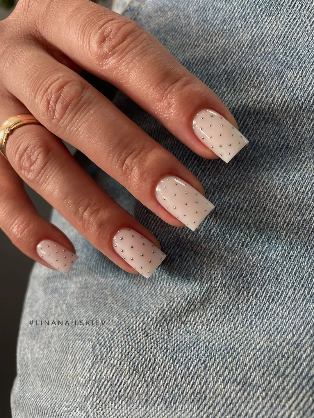 Short cream square nails with small black dot pattern