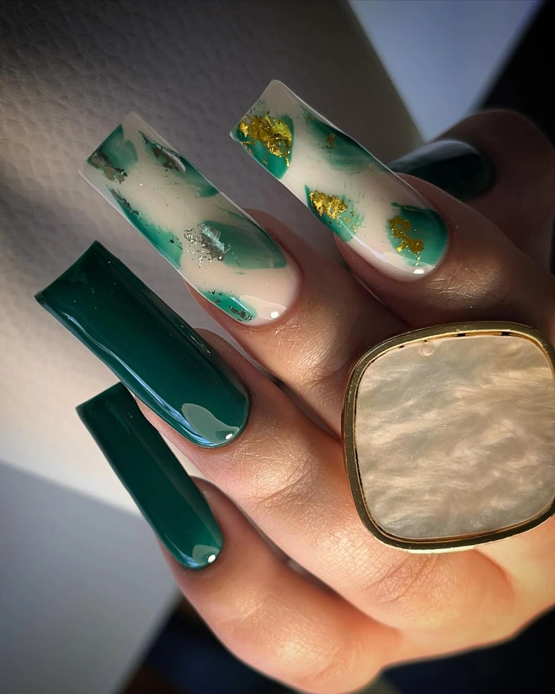 Long square emerald nails with milky green and gold accents