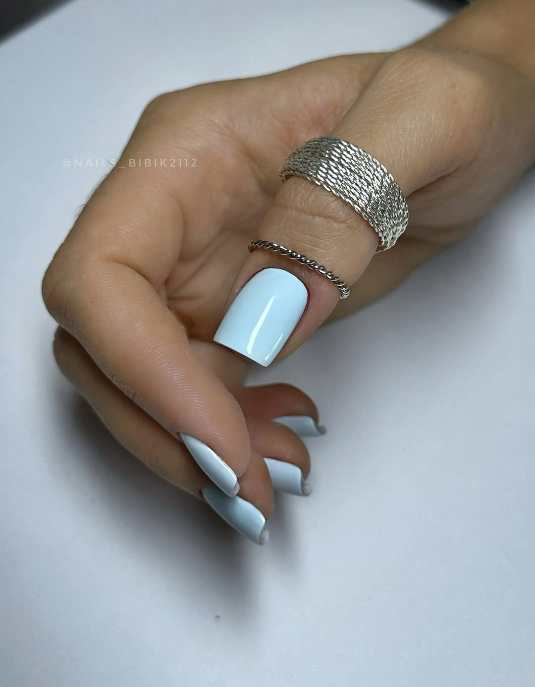Medium square nails in icy blue with white edge details
