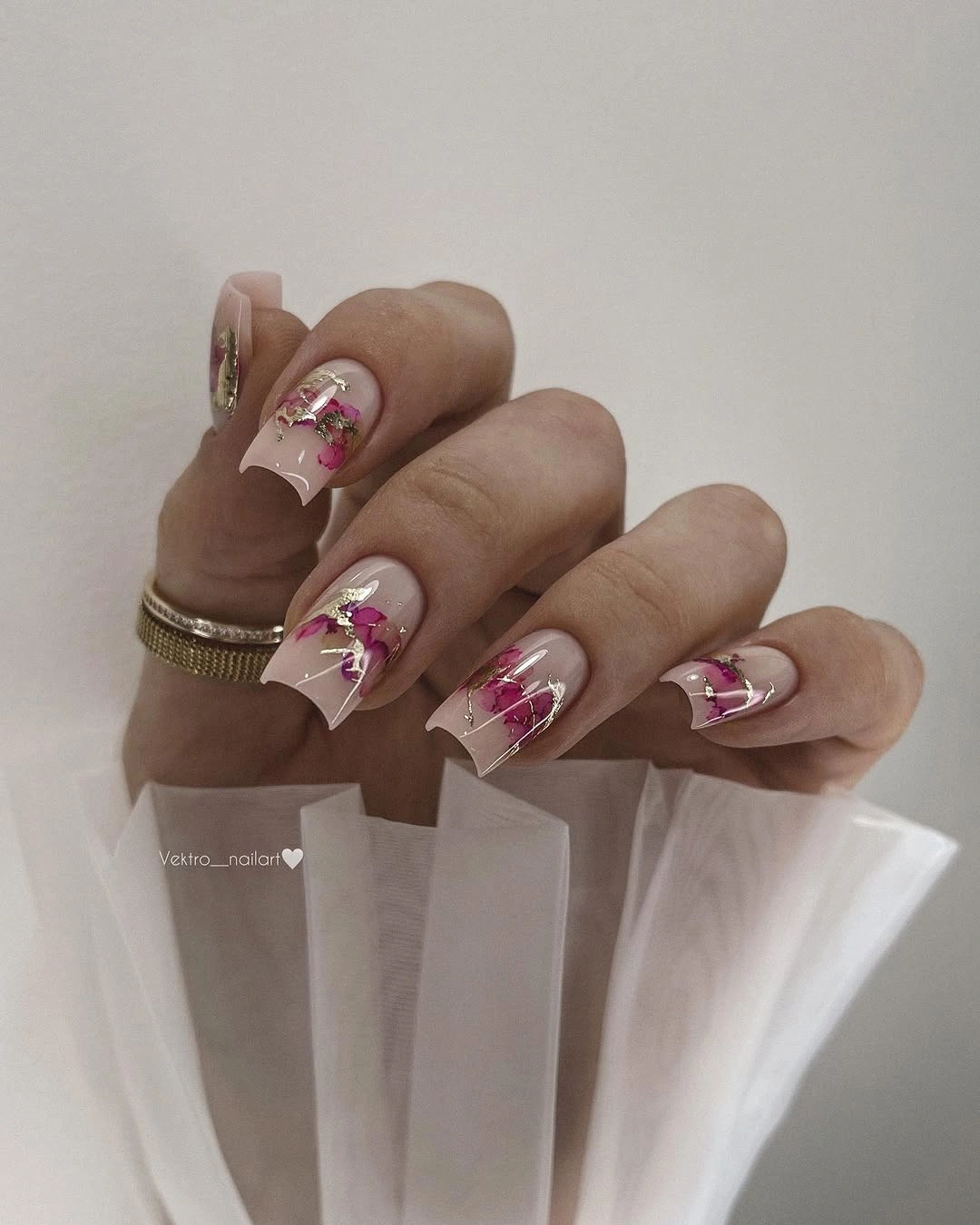 Long translucent pink square nails with white tips and floral accents