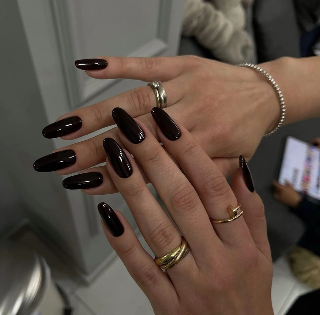 Long almond nails in glossy near black brown