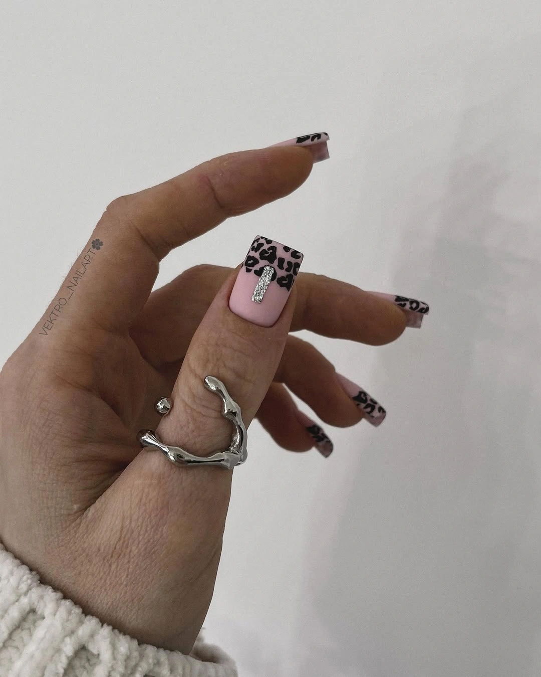 blush square nails with spaced black irregular accent marks