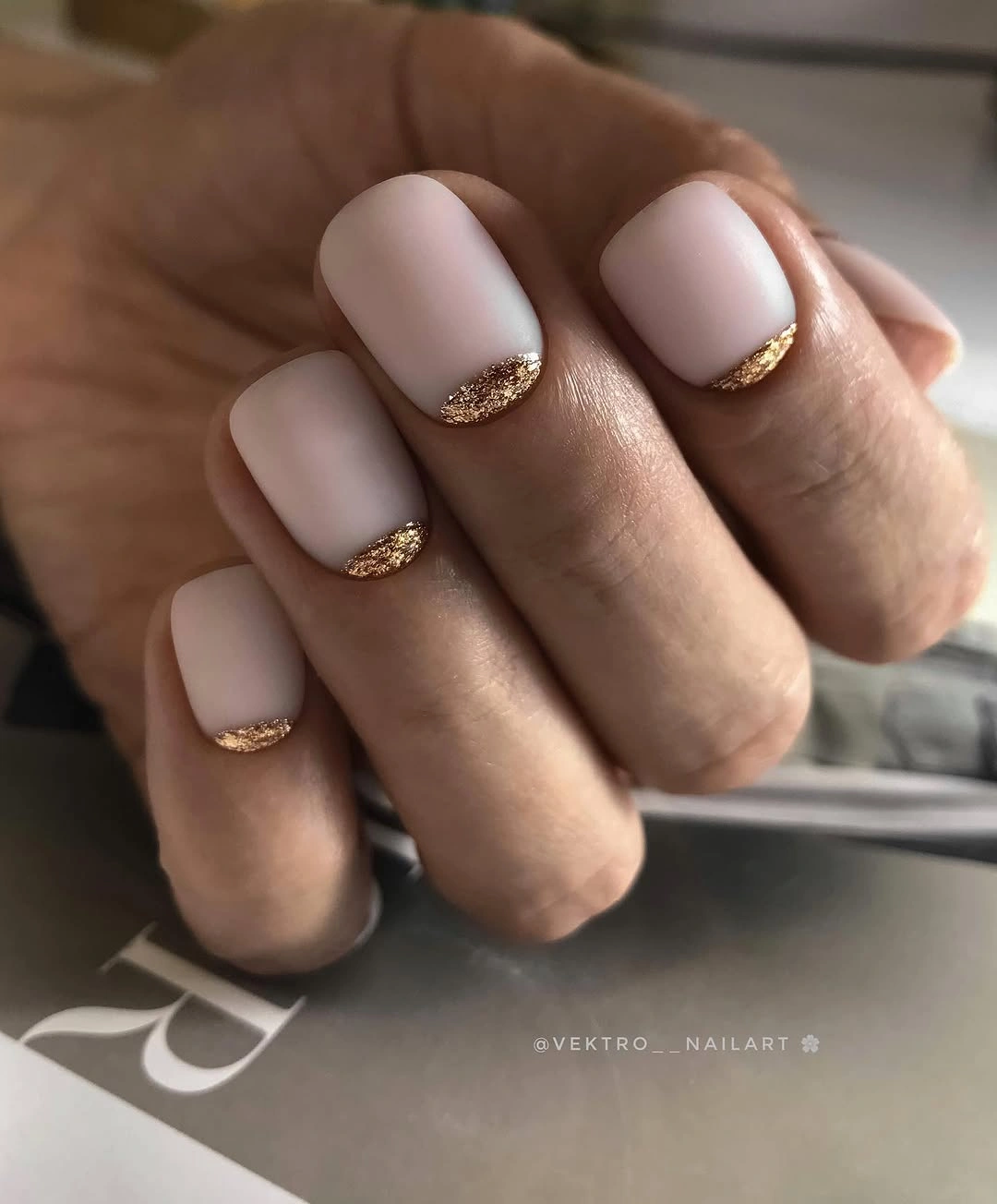 short nude pink square nails with a delicate gold-looking French edge
