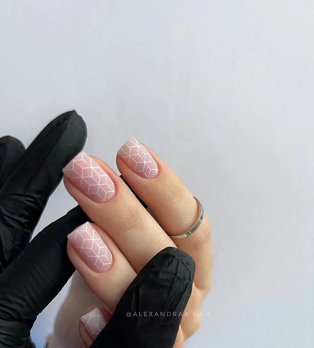 pale pink square nails with a subtle low-contrast lattice pattern