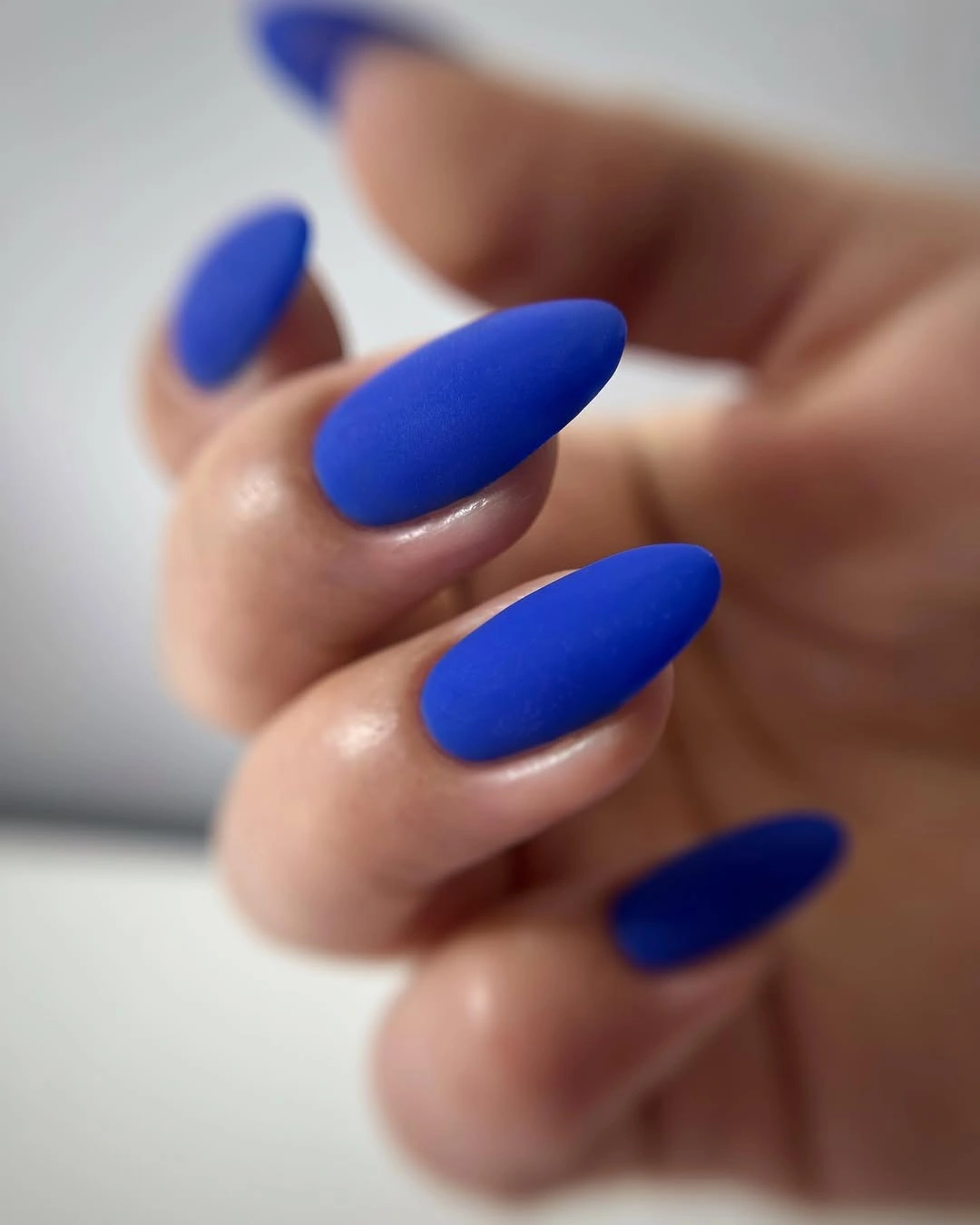 matte cobalt blue almond nails in a saturated solid shade