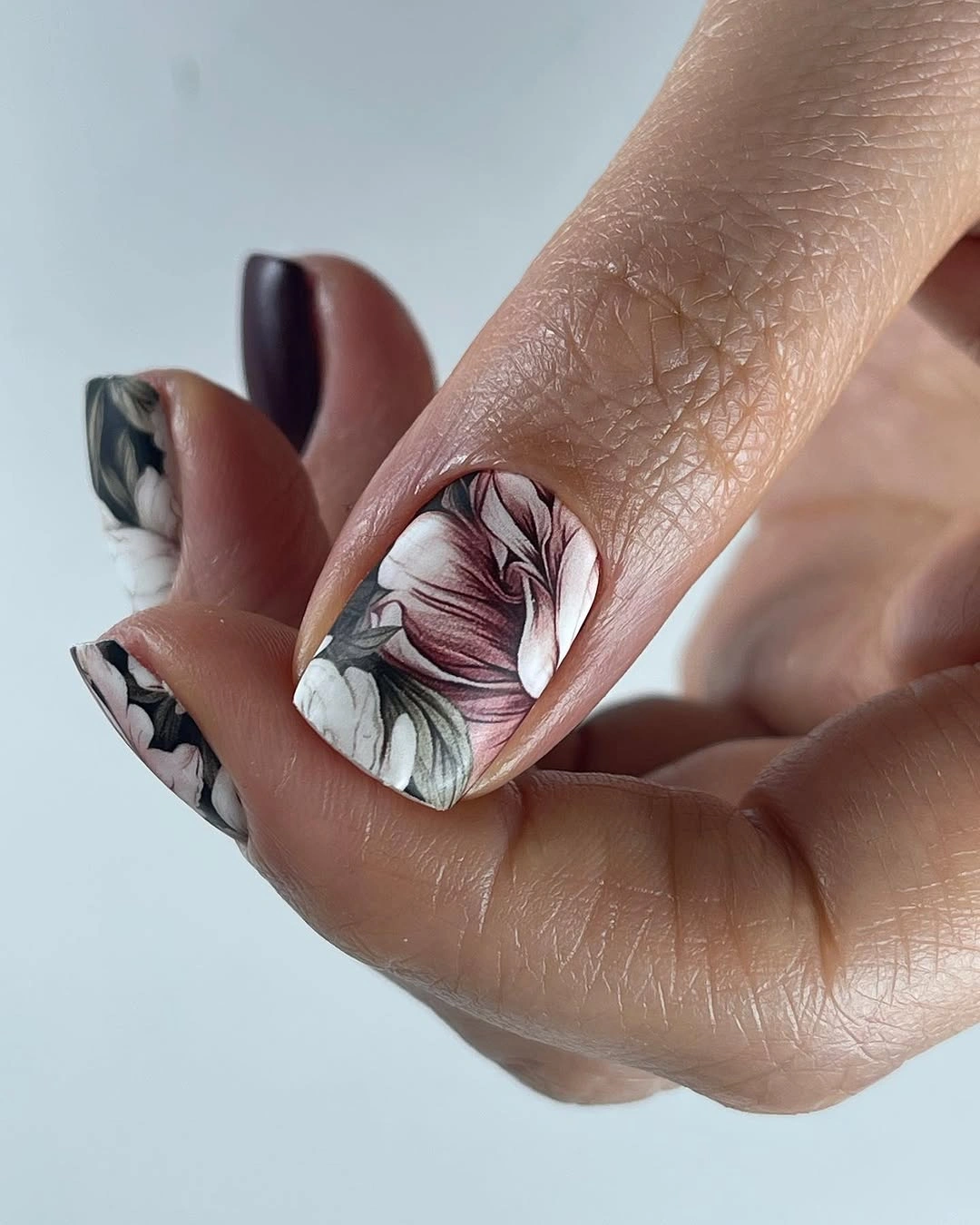 deep plum square nails with one pale botanical accent detail